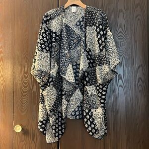 NXG black, white with orange shrug. One Size.